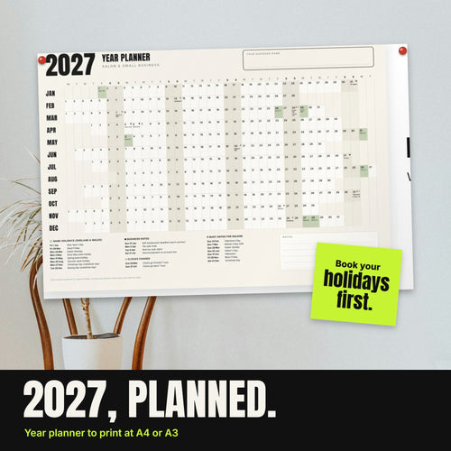 2027 year planner pinned to a studio wall with a lime sticky note